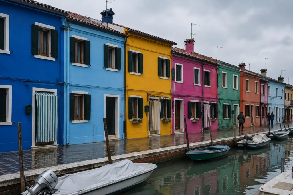 Rainbow-colored houses along a canal in Burano, Venice