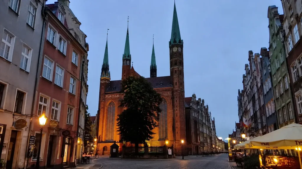 St. Mary's Church illuminated at dusk in Gdańsk's Old Town