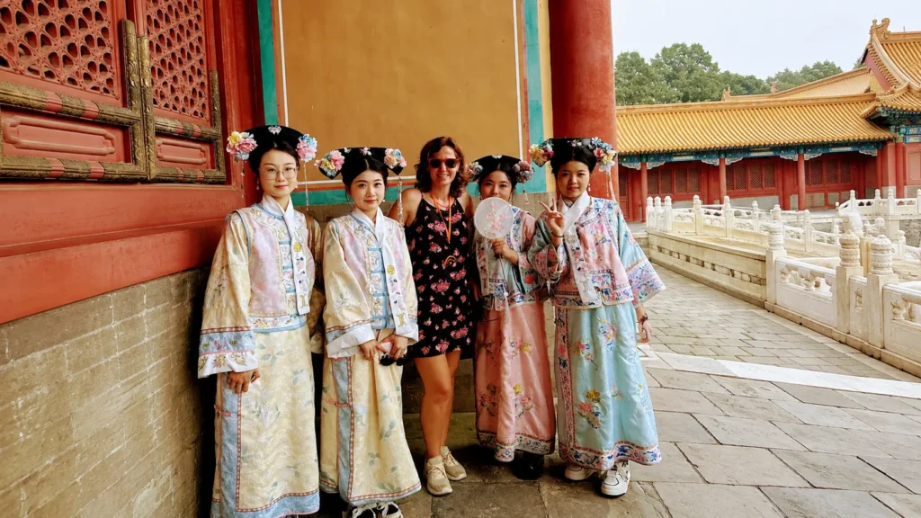 traveler posing with local visitors dressed in traditional Qing-style costumes inside the Forbidden