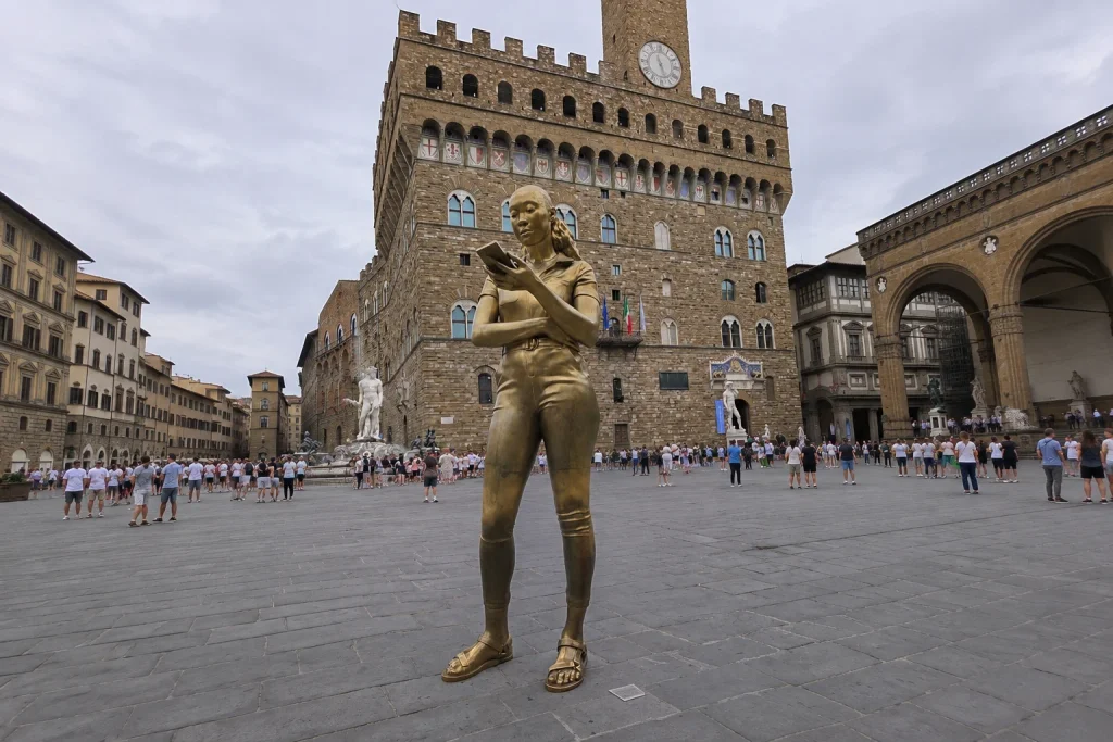 Contemporary bronze statue of a woman with a phone in Piazza della Signoria, Florence