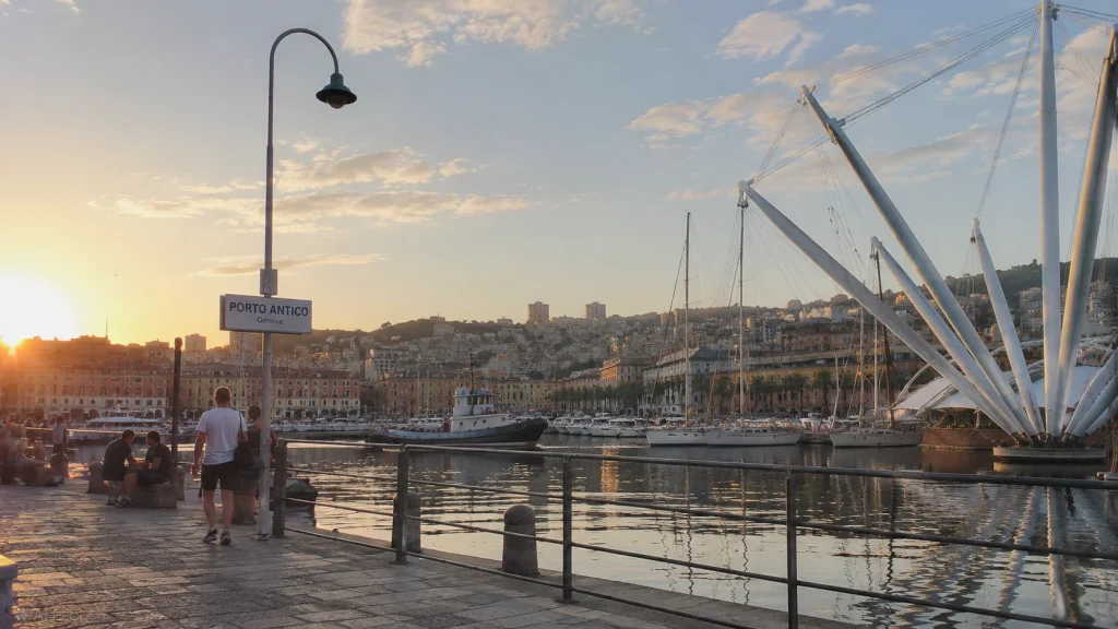 Porto Antico waterfront in Genoa, Italy, at sunset.