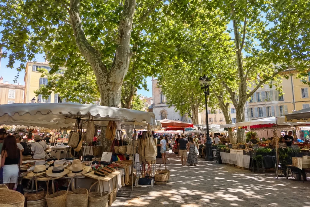 Provençal market stalls under plane trees at Place des Lices in Saint-Tropez.