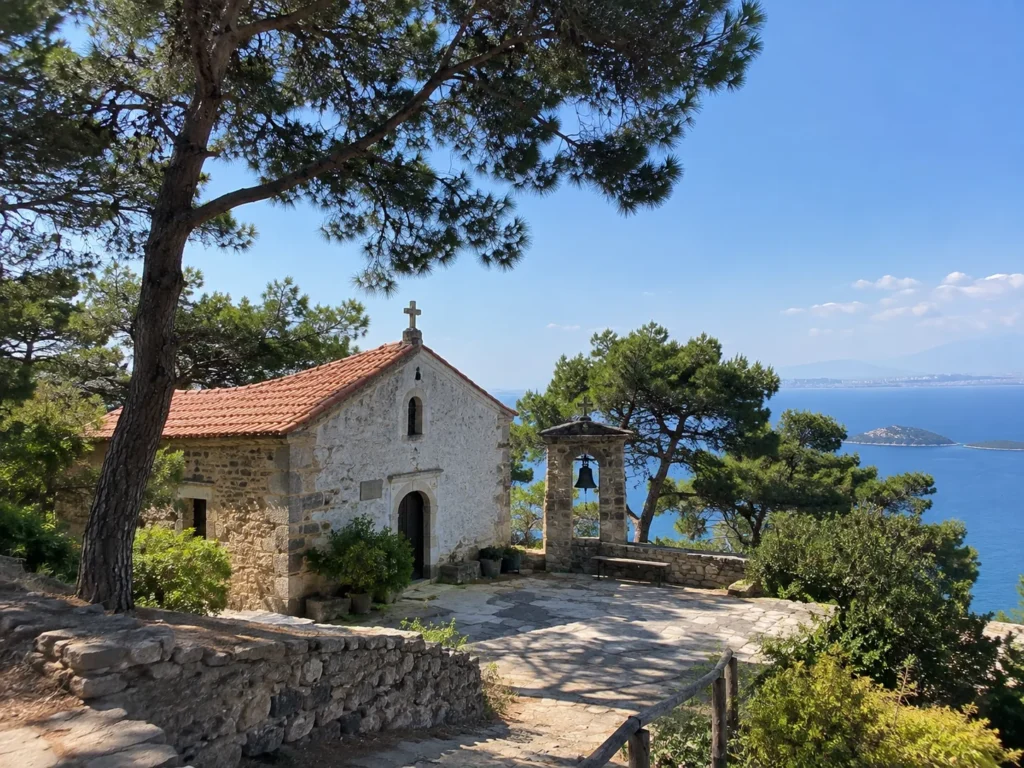 Small stone chapel with a red tile roof and bell tower under pine trees on Burgazada, with sea views over the Princes’ Islands
