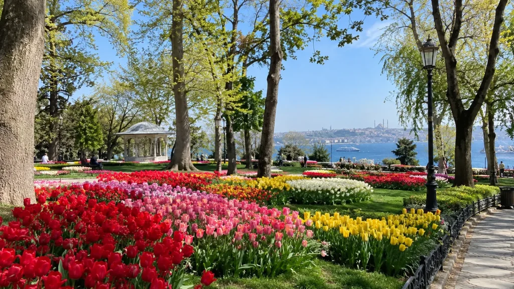 Colorful tulip beds in an Istanbul park in April with a gazebo and the Bosphorus in the background
