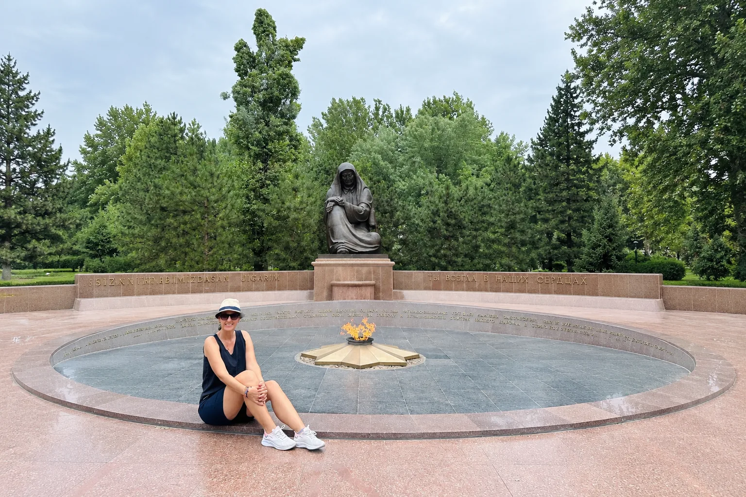 Tashkent travel guide: traveler sitting by the eternal flame at the Mourning Mother memorial in Tashkent