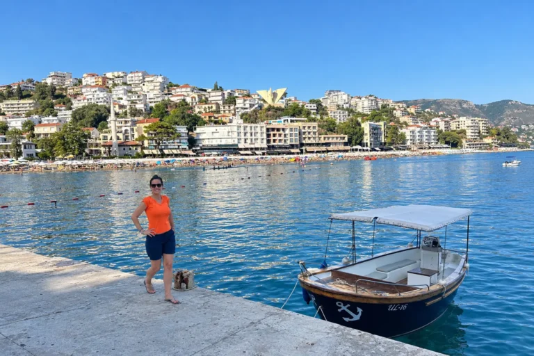 Ulcinj travel guide: the Mala Plaža beach and hillside town seen from the harbour pier in July